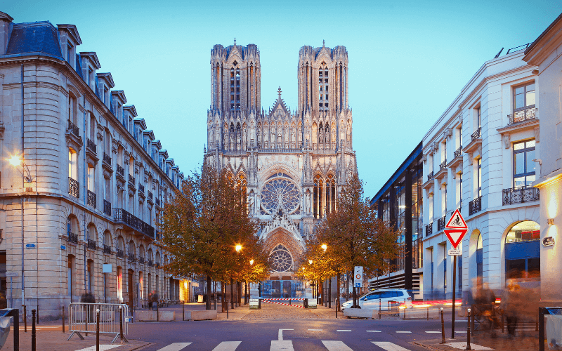 Front view of the Reims Cathedral with its nearby buildings