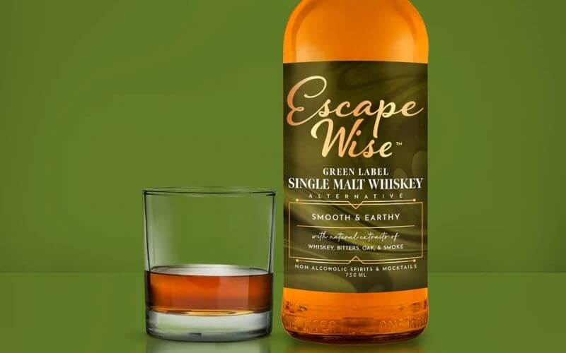 Glass and bottle of Escape Mocktails Single Malt Scotch