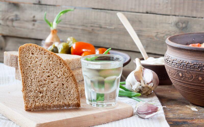 Glass of Horilka with bread and garlic