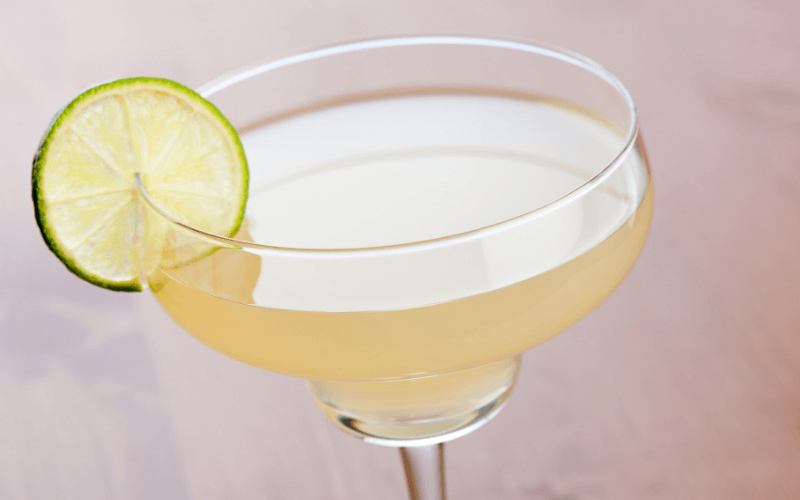 Glass of margarita mocktail with a lime wheel