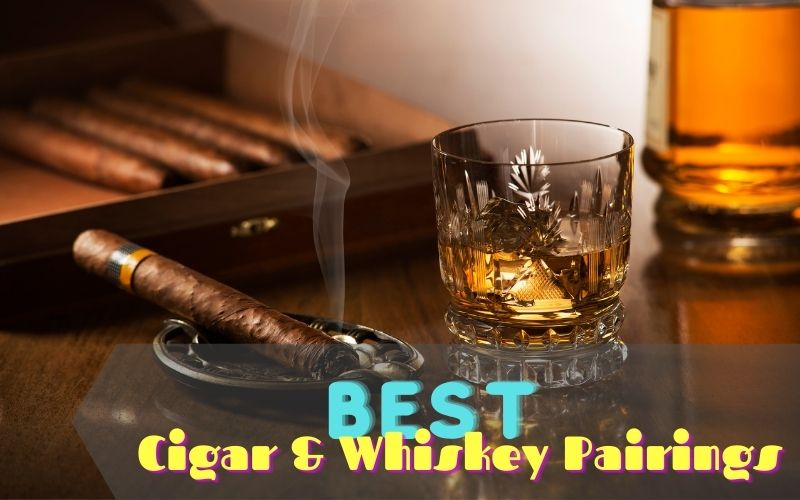 Glass of whiskey beside a lighted cigar in an ashtray
