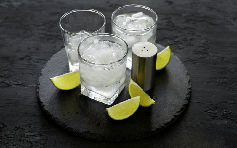 Glasses of Kansan Ice Water in a black wooden surface
