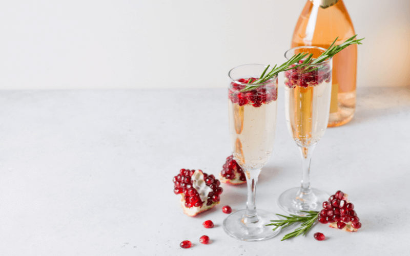 Glasses of St. Germain pomegranate spritzer in a light background