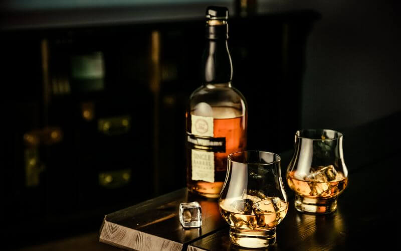 Glasses of bourbon beside Bourbon Whiskey bottle