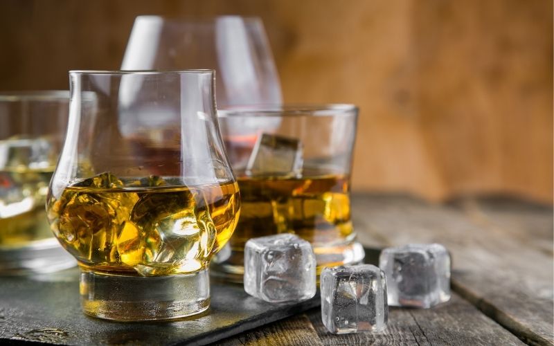 Glasses of bourbon with ice cubes