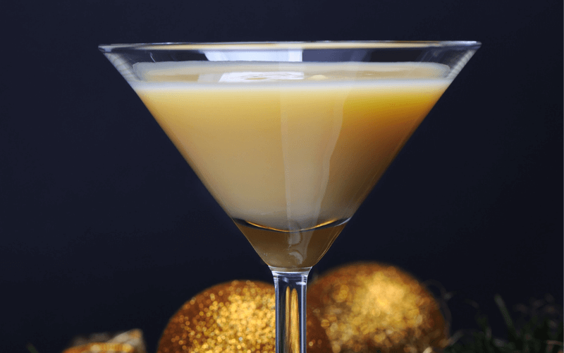 Glasses of classic snowball with spices in a festive white background