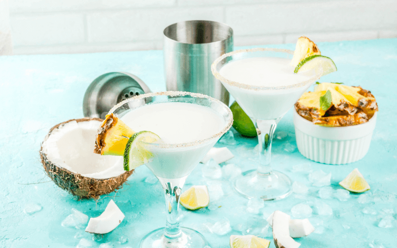 Glasses of frozen coconut margaritas in a light background