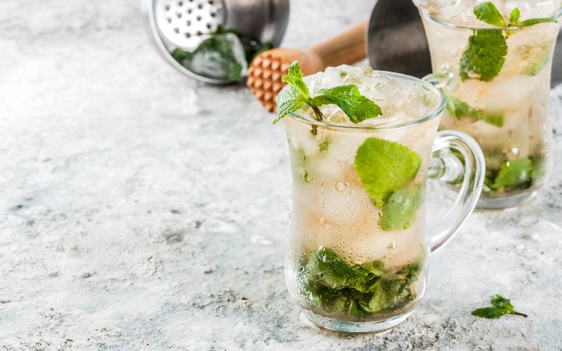 Glasses of mint julep on a marble surface