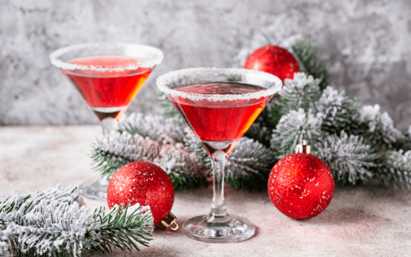 Glasses of pomegranate martini in a white christmas background