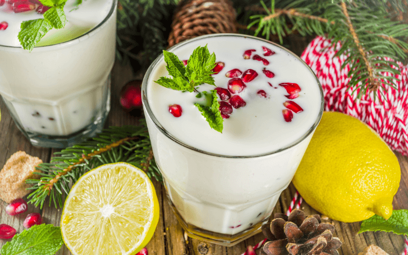 Glasses of white Christmas mojito in a wooden surface