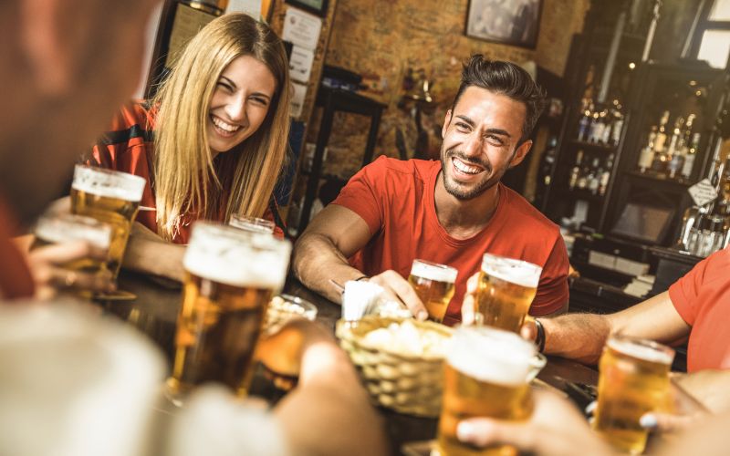 Happy Friends Drinking Beer at a Restaurant