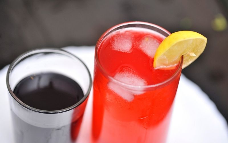 A glass of screwdriver cocktail in a wooden table