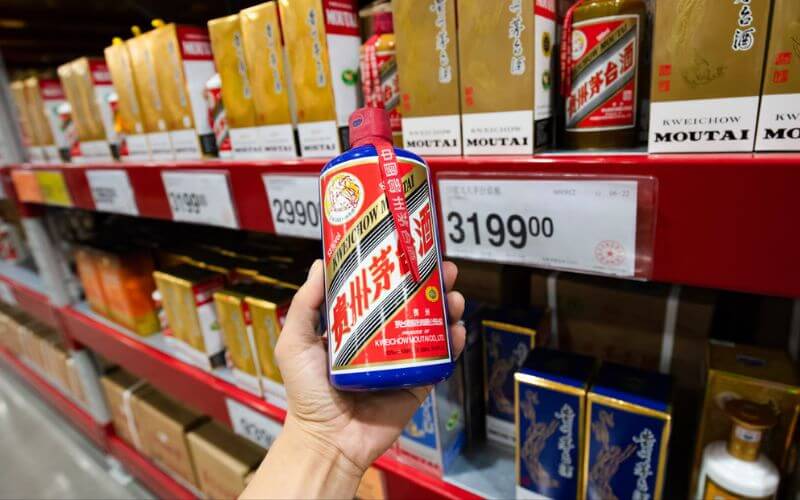 Holding a bottle of Maotai in a store - Image by RADII