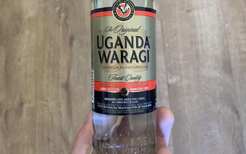 Holding a bottle of Waragi - Image by You Well
