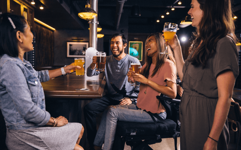 Group of friends happily drinking beer