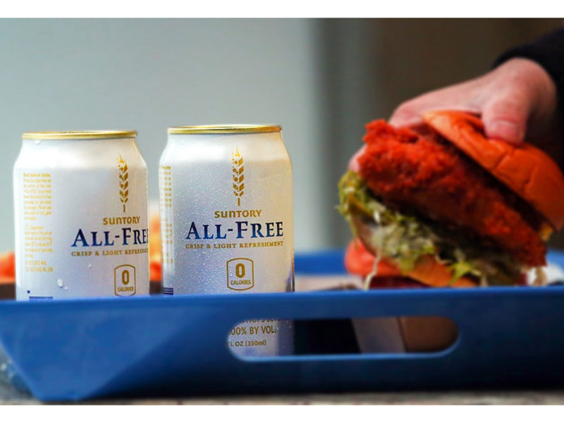 Suntory All-Free with man holding a burger