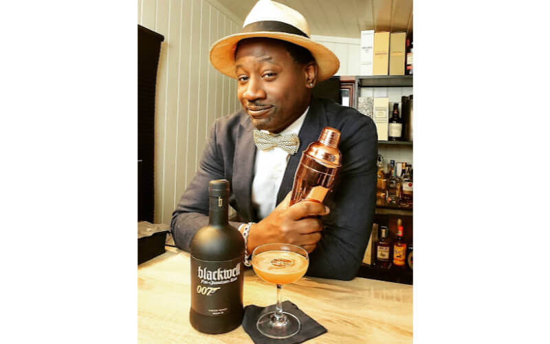 Ian Burrell holding a cocktail shaker