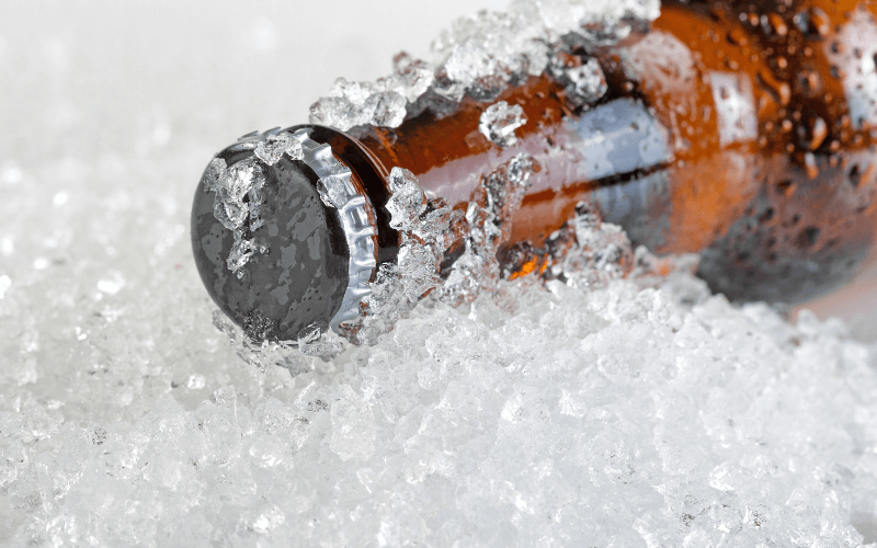 Cold beer bottle on top of crushed ice