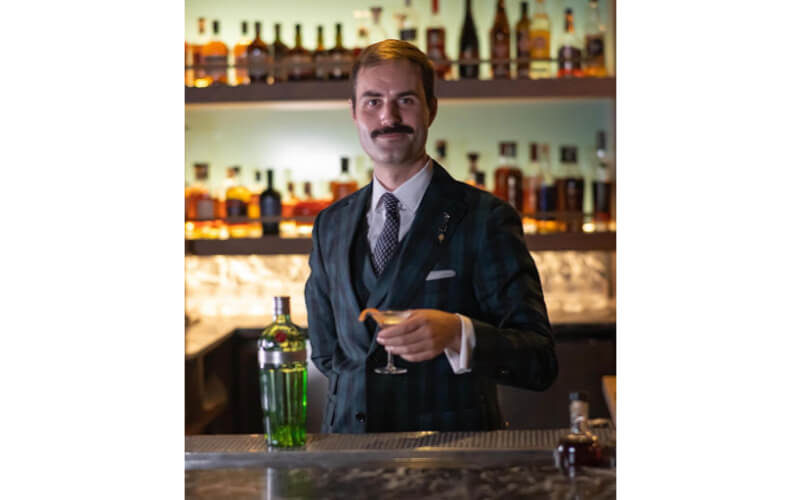 James Grant holding a glass of liquor