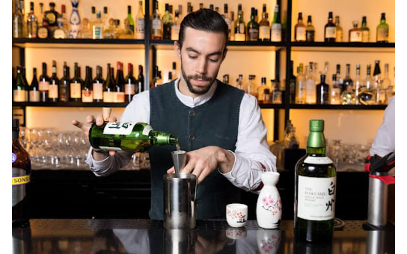 Jeremy Le Blanche using a cocktail jigger 