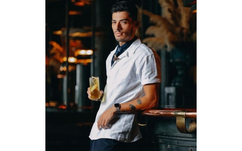 João Costa holding a glass of cocktail