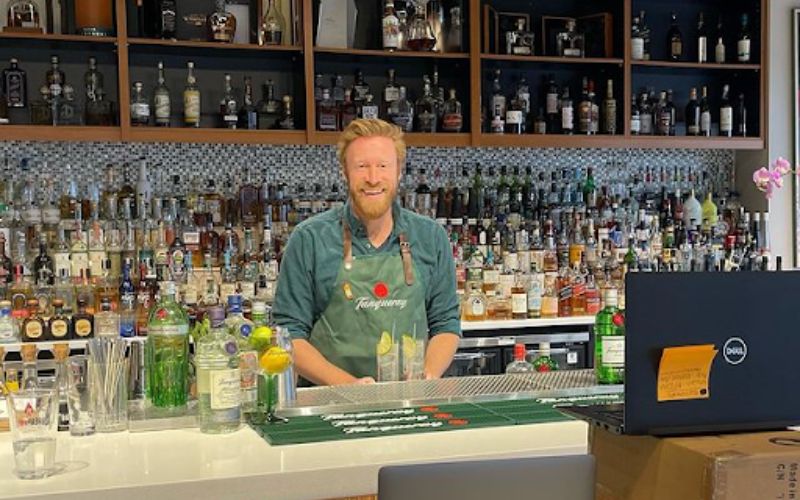 John Henderson making a cocktail in a bar