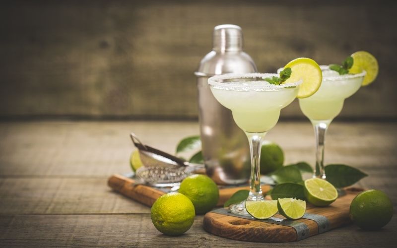 A glass of margarita with lime