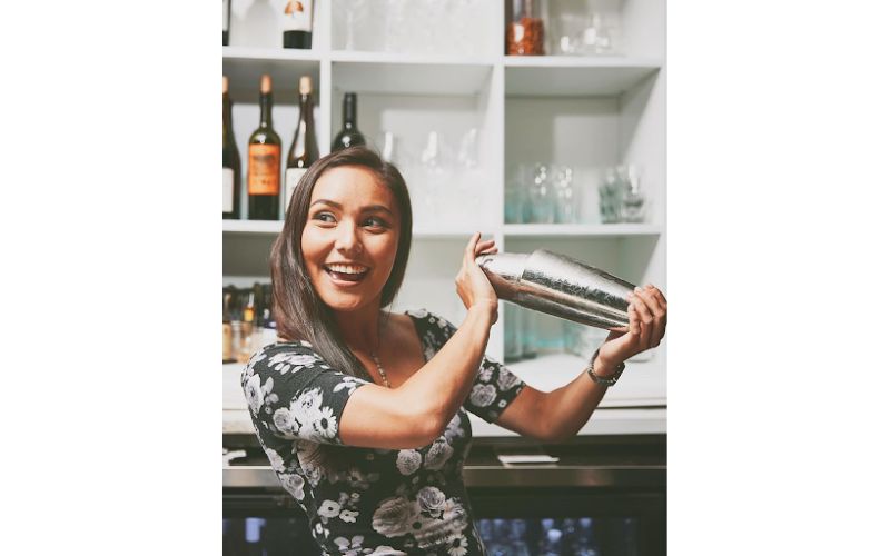 Kira Webster making a cocktail in a bar