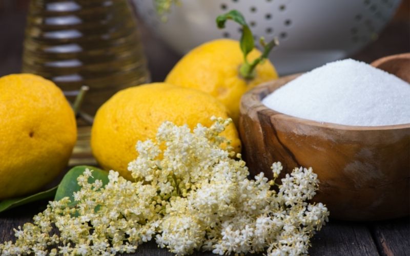 Lemons, a bowl of sugar, and elderflower