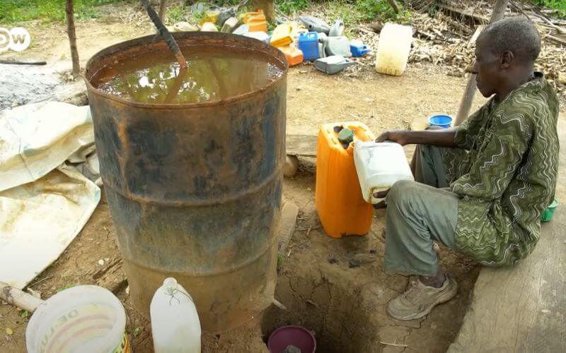 Man distilling Akpeteshie - Image by DW Food