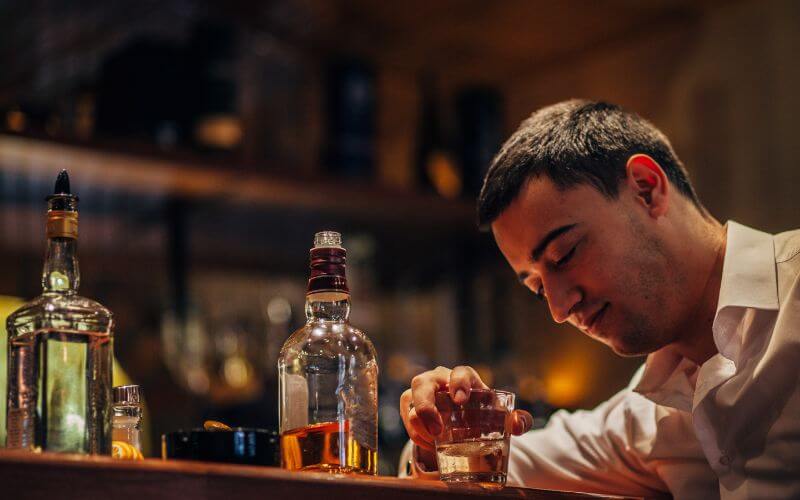 Man drinking tequila in a bar