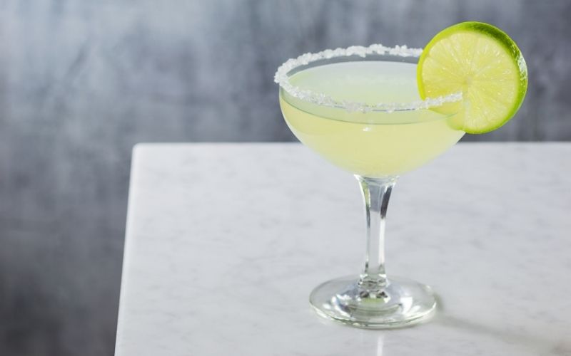 Margarita garnished with a salt rim and a lime wheel
