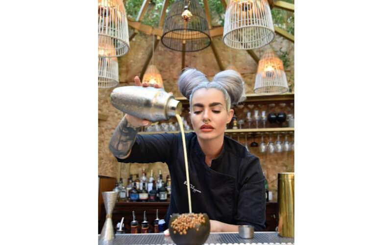 Mary Talaiporou pouring liquor