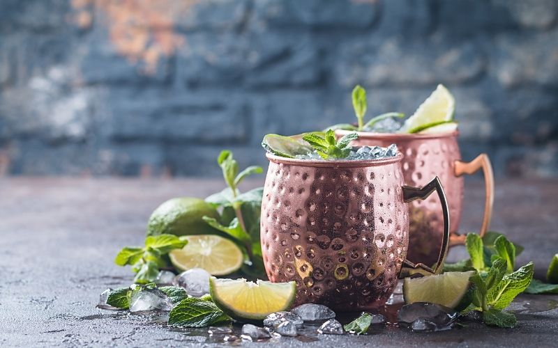 Moscow mule cocktail garnished with fresh herbs