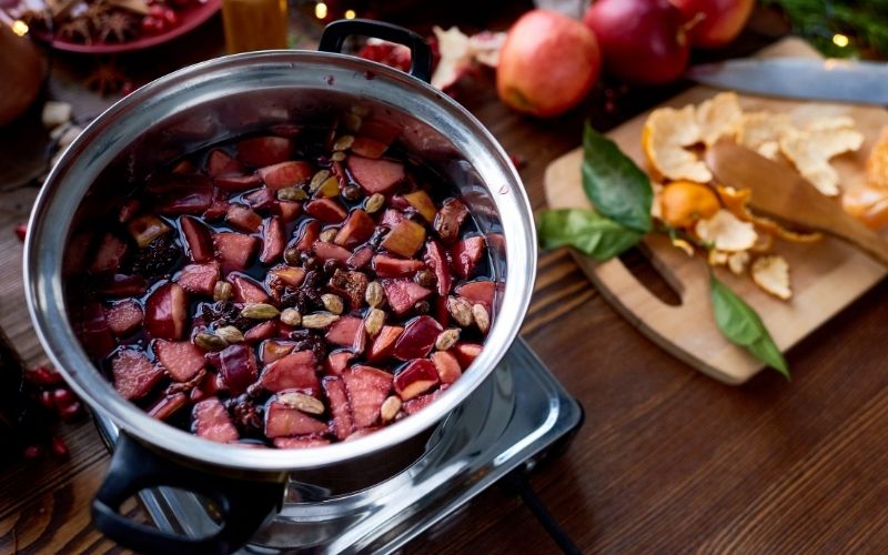 Mulled wine ingredients mixed in a saucepan