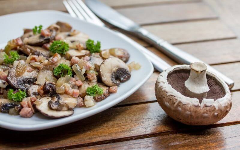 Mushroom dish beside a whole mushroom