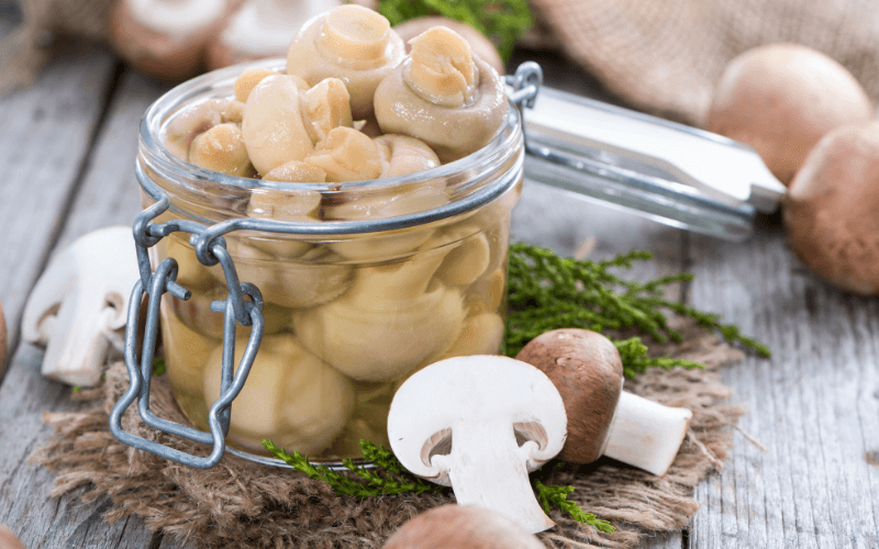 Mushrooms with liquid in an open jar