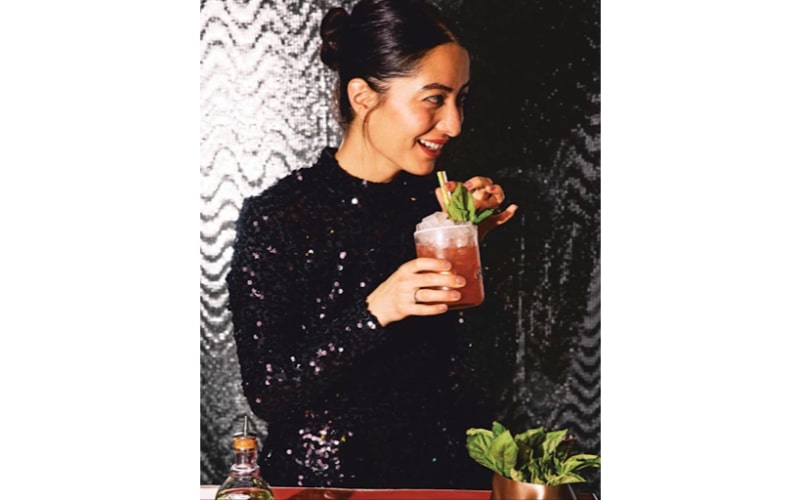 Natasha David drinking a cocktail
