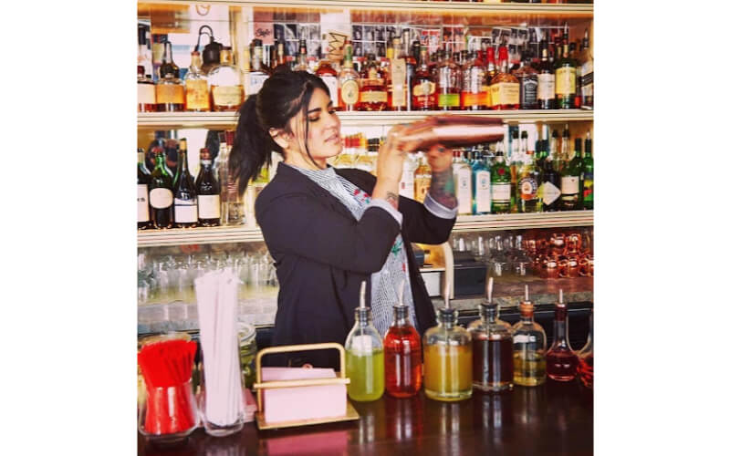 Natasha Sofia using a cocktail shaker
