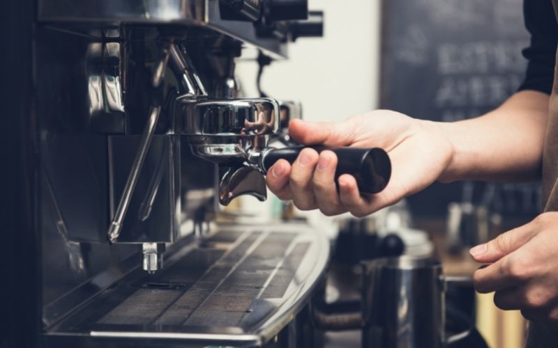 Man holding coffee machine