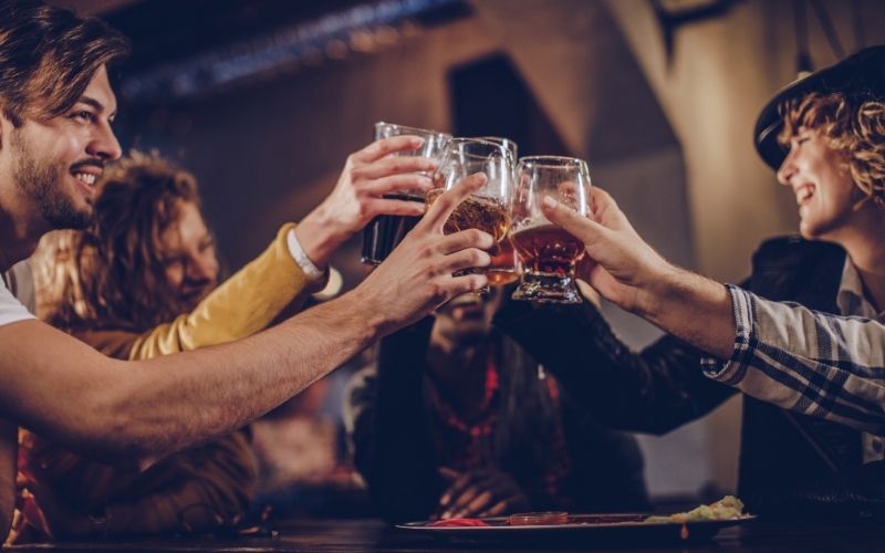 People toasting beer glasses