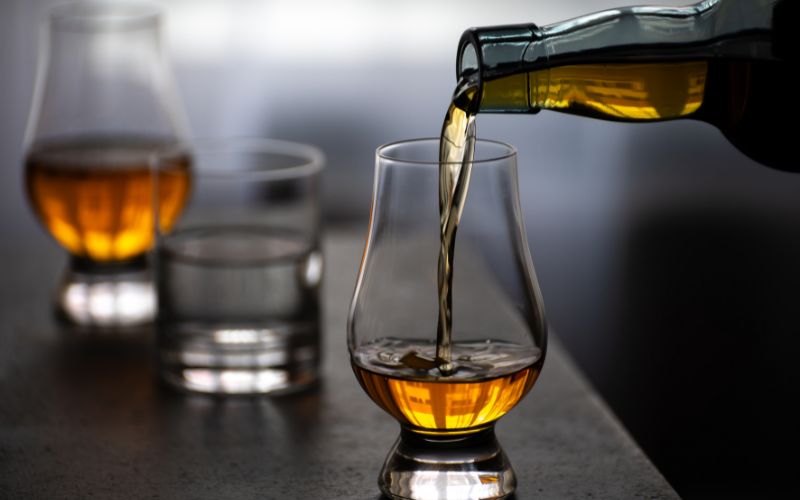 Pouring Scotch in tulip-shaped tasting glass