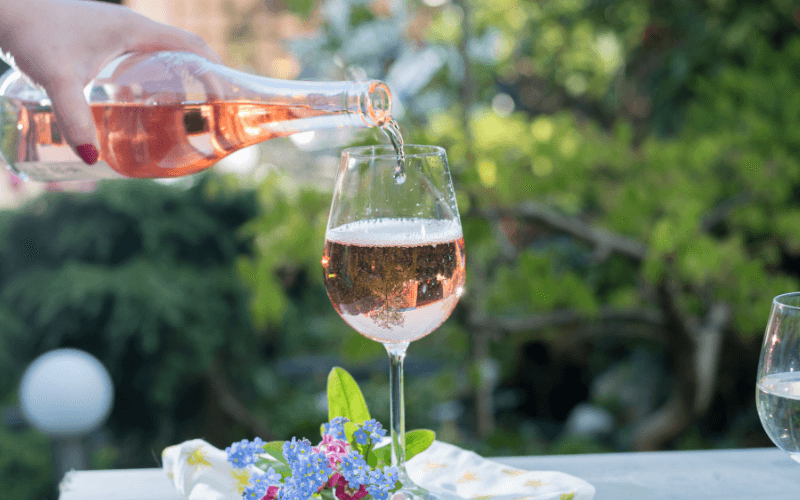 Pouring a glass of cold rose wine