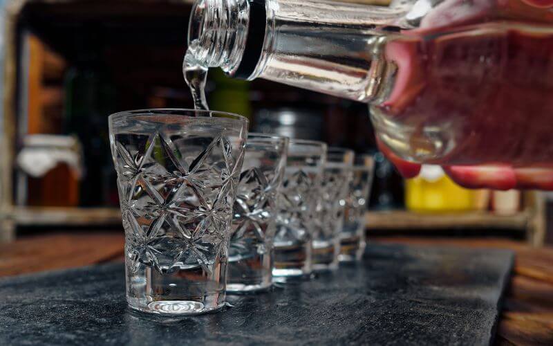 Pouring grain alcohol into shot glasses