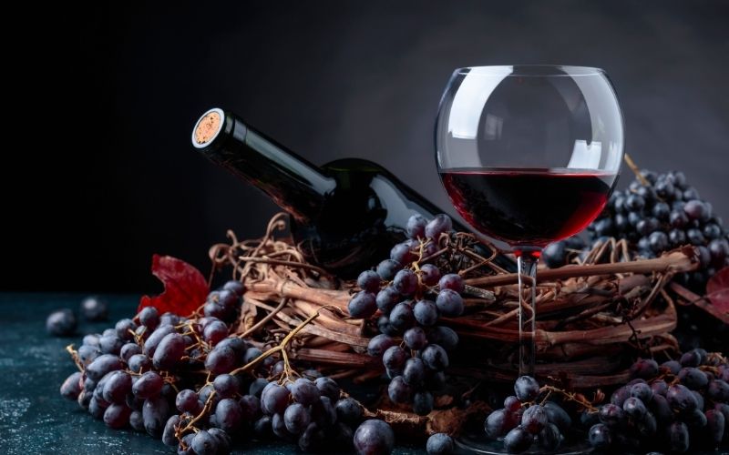 Red wine and grapes in a basket