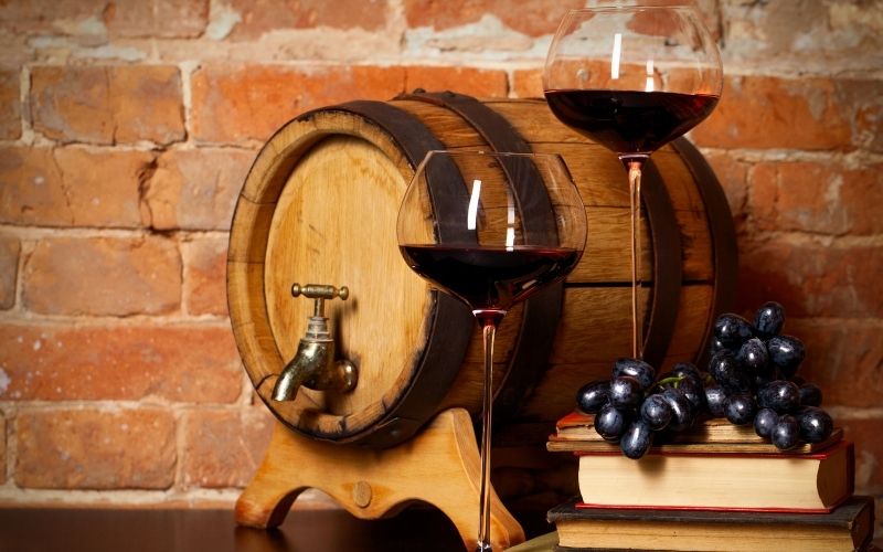 Retro still life with red wine and barrel