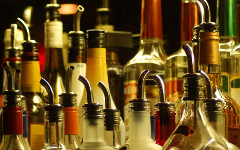 Shelf of liquor bottles with liquor pourers
