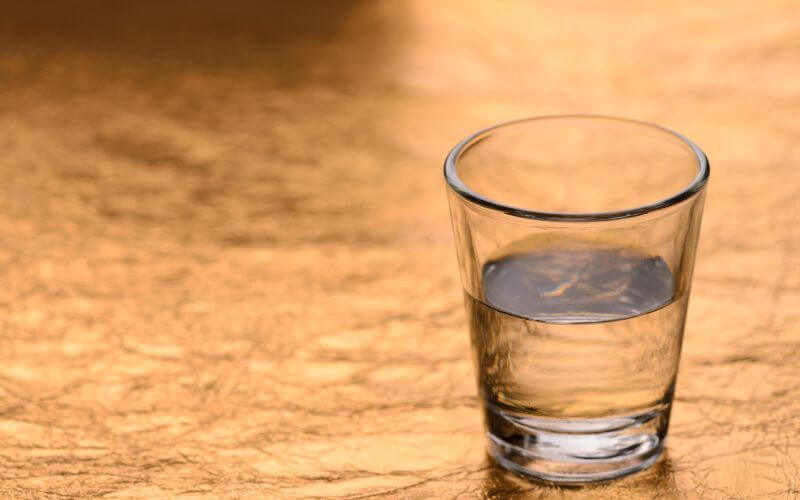 Shot Glass On Gold Background