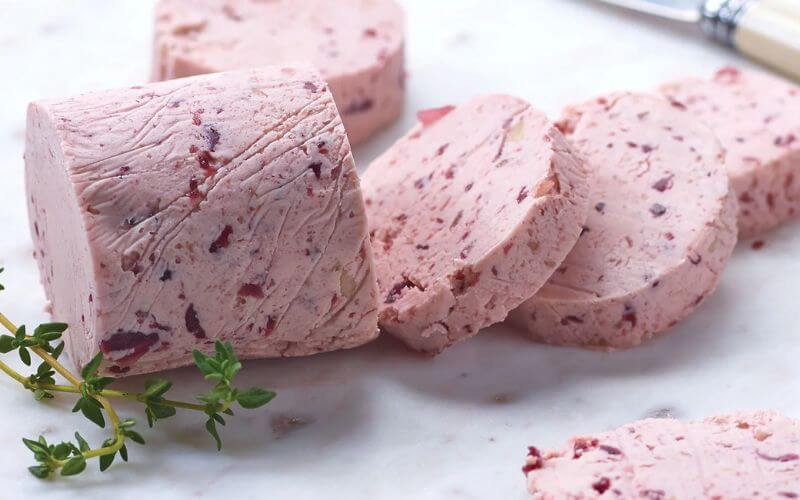 Slices of red wine butter with herbs