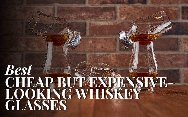 Stacked whiskey glasses in front of a brick wall  